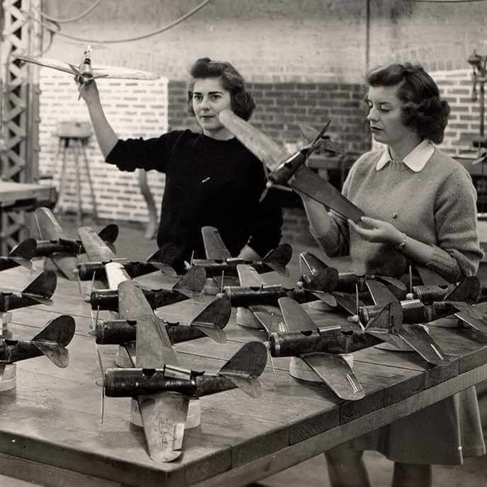 Black and white image of two women in the Curtiss-Wright Engineering Cadettes Program with model planes, 1943.