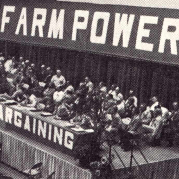 Black and white image of farmers discussing collective bargaining. 